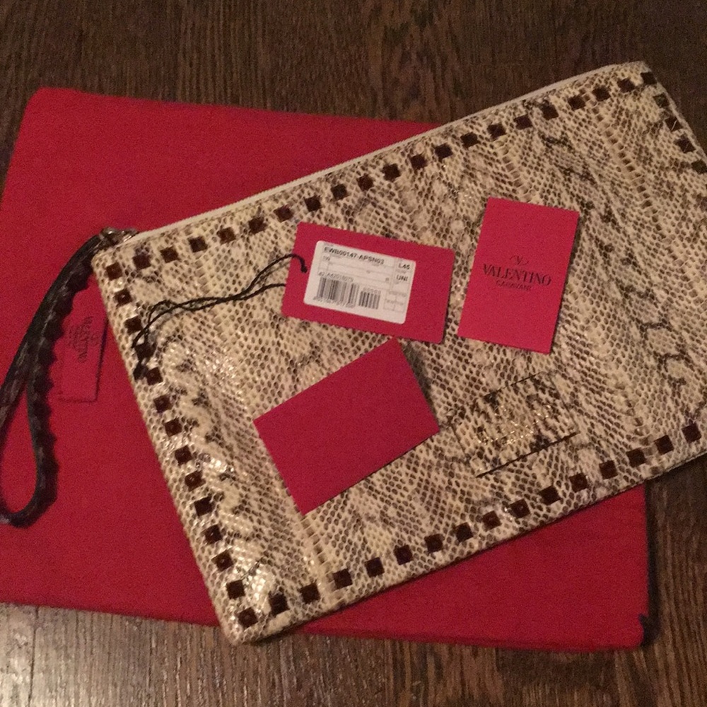 Rare Valentino snakeskin rockstud clutch.